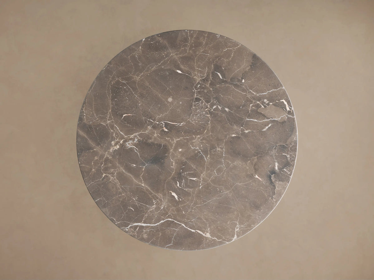 Saint Germain Round Stone Dining Table close-up. Dark espresso marble top with intricate white veining and natural variations.