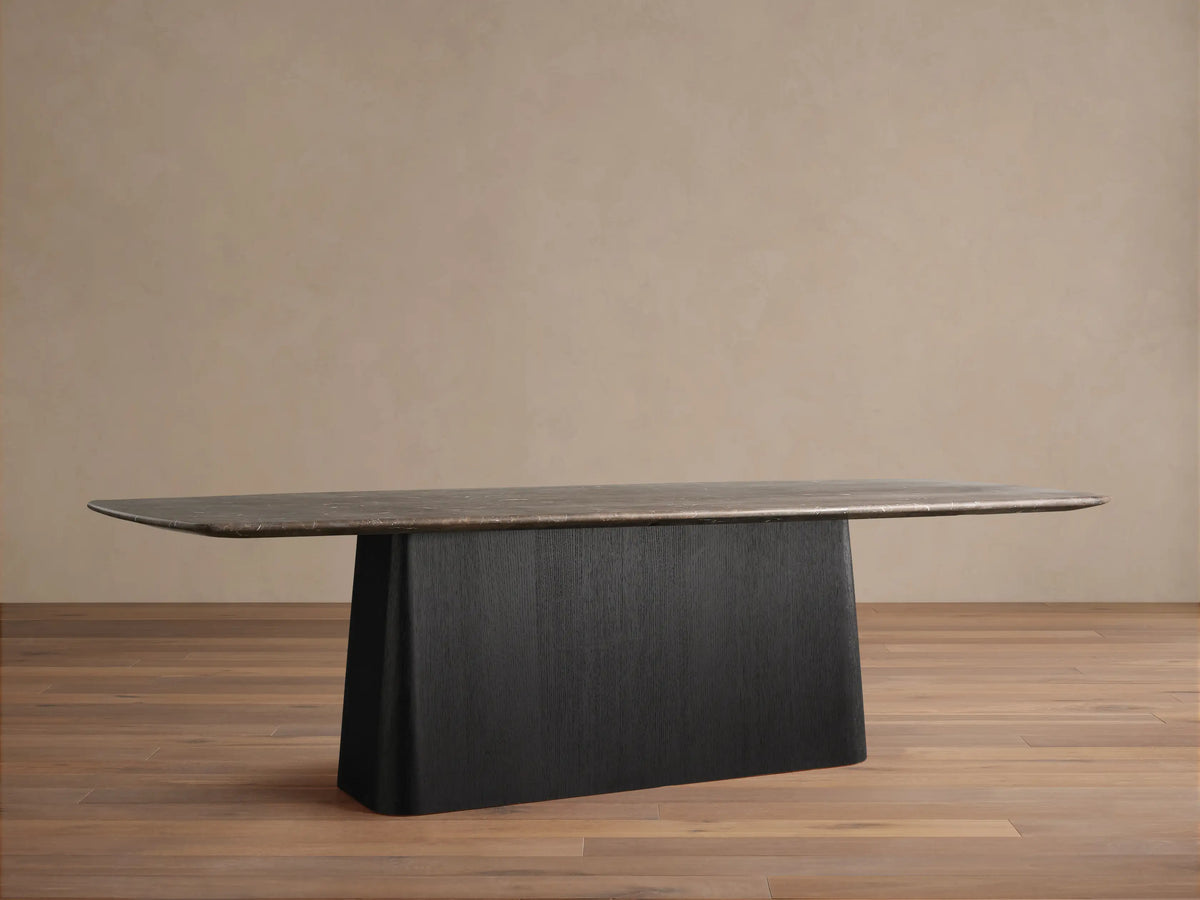 Saint Germain Dining Table. Rectangular espresso brown stone top with rounded corners on a dark, solid Toulouse base.