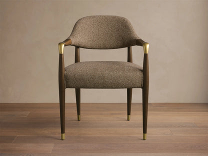 Front view of the Evelyn Dining Arm Chair with brown tweed upholstered seat, dark mahogany frame, and brushed brass accents.
