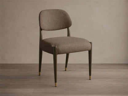 Front-quarter view of the Evelyn Dining Side Chair with textured brown upholstery, dark mahogany legs, and brushed brass accents.