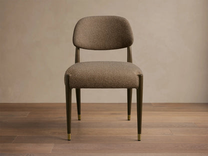 Front view of the taupe textured Evelyn Dining Side Chair, featuring dark mahogany wood legs and brushed brass caps.