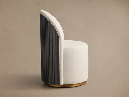 Front view of a cream Finnley Dining Side Chair, featuring a rounded back, cylindrical seat, and a light-finished brass plinth base.