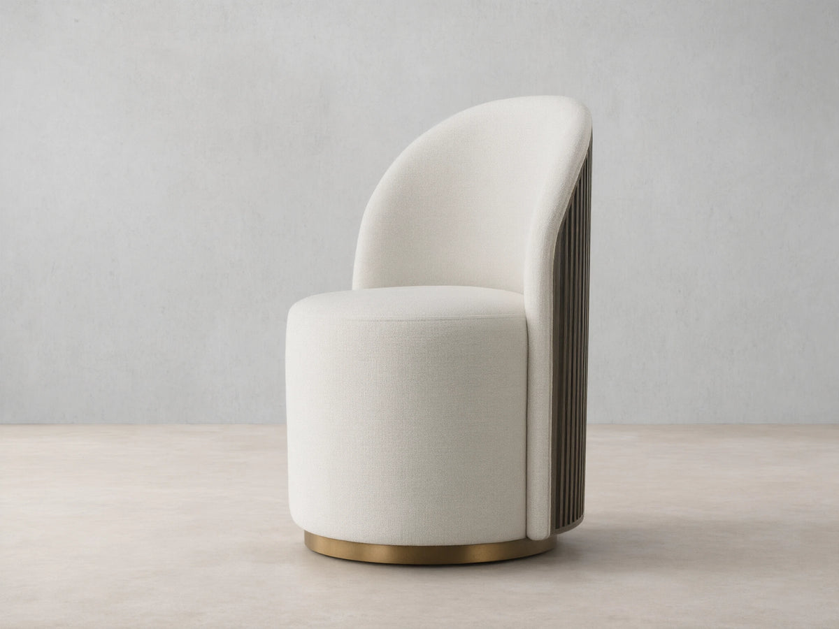 Cream Finnley Dining Side Chair, front-facing, with a curved back, dark reeded wood paneling, and a brass plinth base.