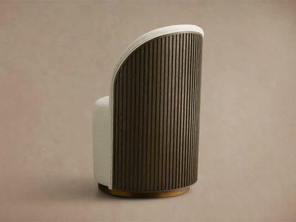 Cream Finnley Dining Side Chair, front-facing, with a curved back, dark reeded wood paneling, and a brass plinth base.