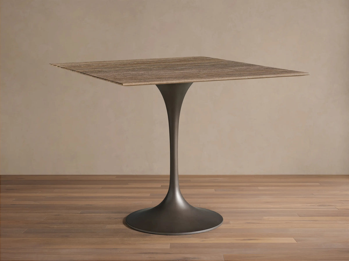 Front view of the Saint Germain Square Bistro Table™ with a streaked honed stone top and dark steel pedestal base.