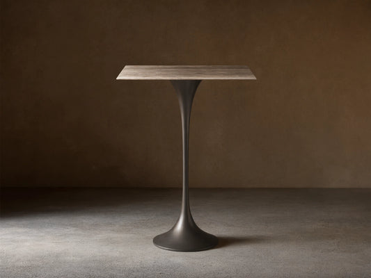 Front view of the Saint Germain Square Bar Table with a light woodgrain square top and a dark tapered pedestal base.