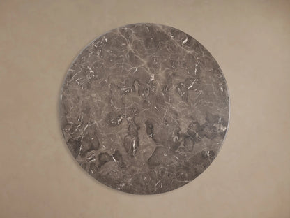 Front view of the Dark grey marble Gabriella Round Stone Dining Table with sculptural fin-style supports and hexagonal base.