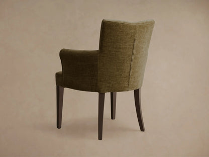 Rear view of the olive green Giovanni Dining Arm Chair™ with dark wooden legs and a vertical back seam.