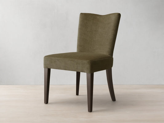 Front view of the olive textured Giovanni Dining Side Chair with a gently curved back and dark wood legs.