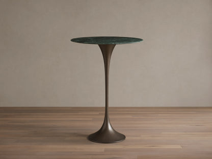 Front view of the Saint Germain Bar Table with a round dark green natural stone top and a dark bronze trumpet-shaped steel base.