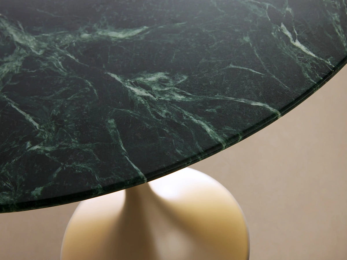 Saint Germain Counter Table with a round green marble top and elegant gold-colored steel pedestal base, set against a neutral background.