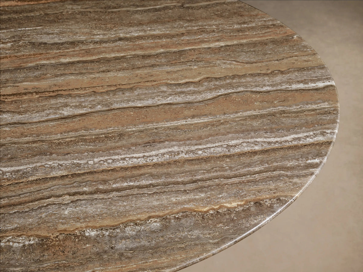 Front view of a Saint Germain Round Stone Dining Table with Toulouse Base, featuring a light brown weathered stone top and a black conical base.