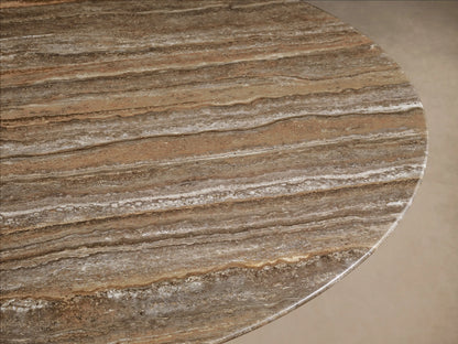 Front view of a Saint Germain Round Stone Dining Table with Toulouse Base, featuring a light brown weathered stone top and a black conical base.