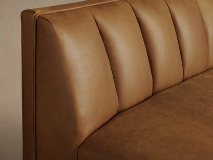 Gates Leather Bench, warm brown leather with channel-stitched backrest, square seat, and dark tapered legs on wood floor.