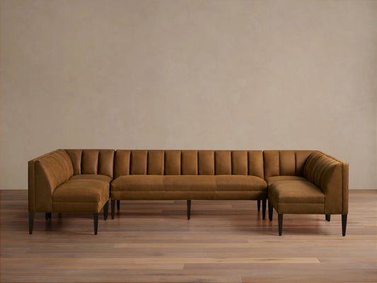 Gates Leather U-Shaped Banquette, rich brown, channel-stitched backrests, dark tapered legs on a wooden floor.