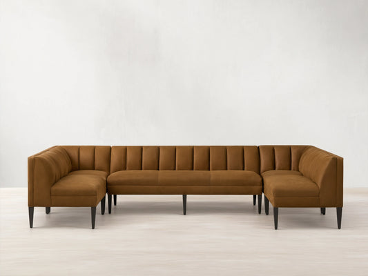 Gates Leather U-Shaped Banquette, rich brown, channel-stitched backrests, dark tapered legs on a wooden floor.