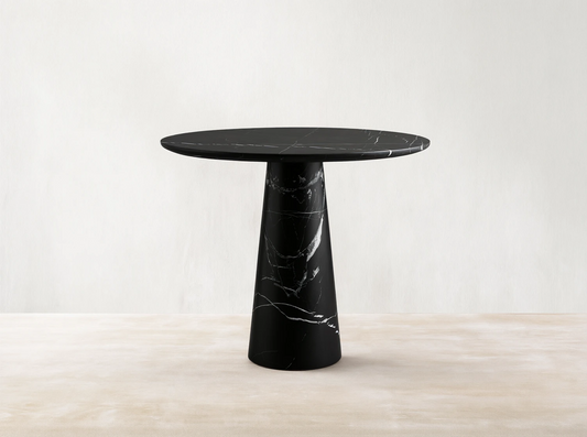 Front view of the Hemmings Bistro Table, a black marble table with a round top and conical base, featuring white veining.