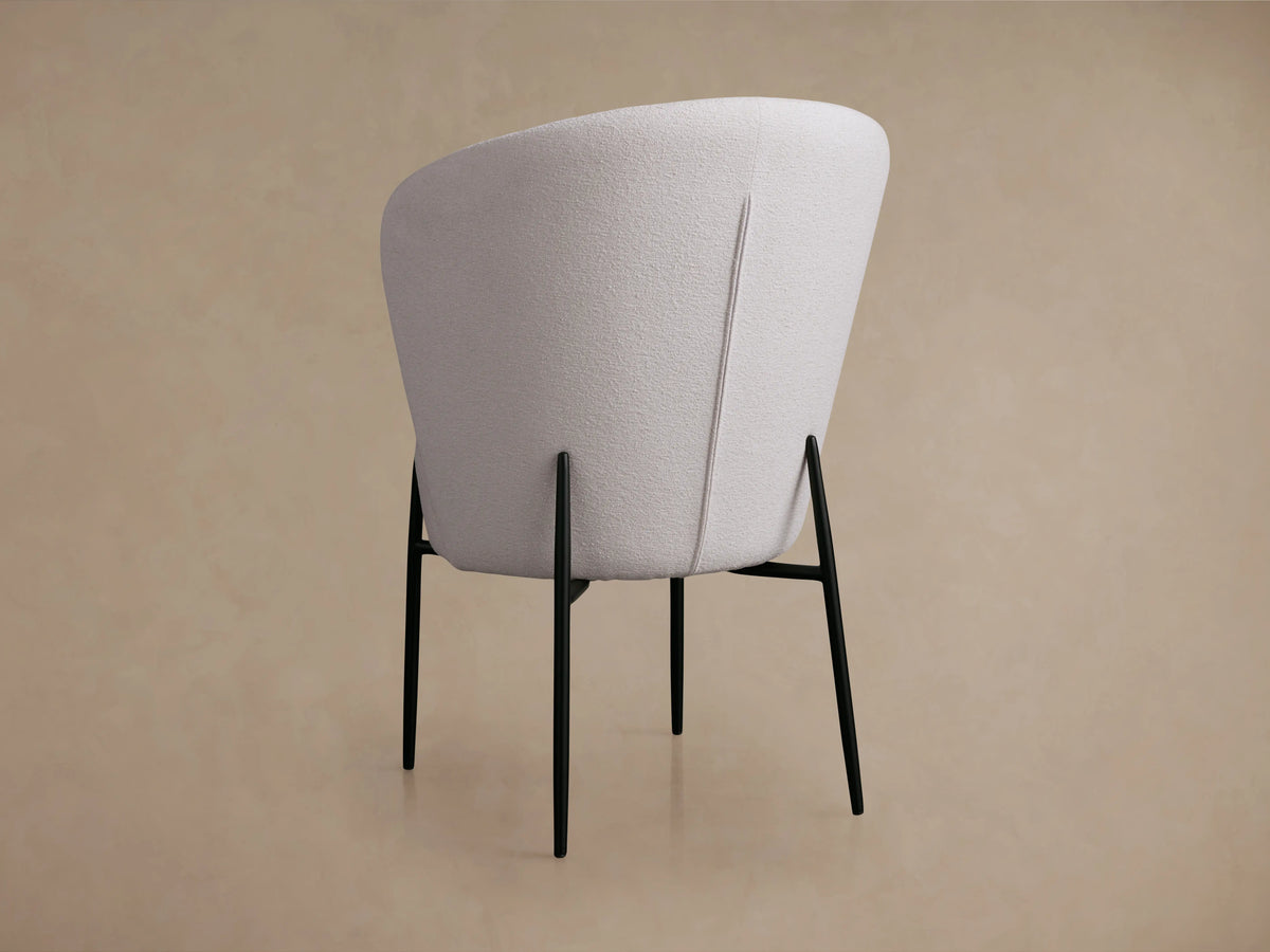 Hanne Dining Captain Chair with textured white Crypton® fabric, round seat, curved back, and black metal legs.