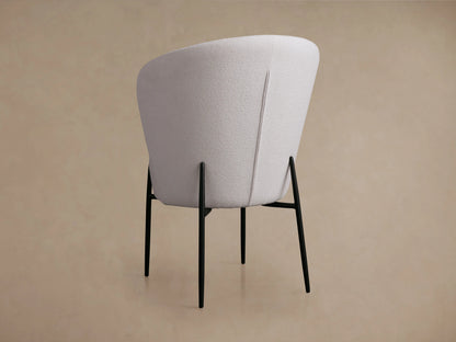 Hanne Dining Captain Chair with textured white Crypton® fabric, round seat, curved back, and black metal legs.