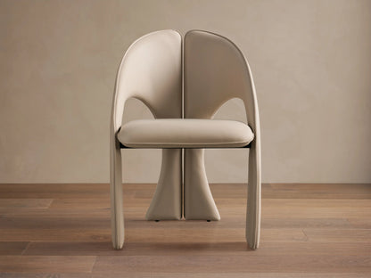 Front view of the cream Hearst Dining Side Chair, fully upholstered with a distinctive split-back design and integrated curved legs.
