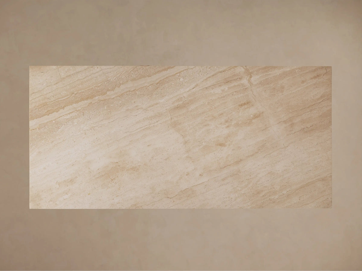Top-down view of the Ilaria Dining Table's rectangular beige coralle marble top, with natural linear light and dark veining.