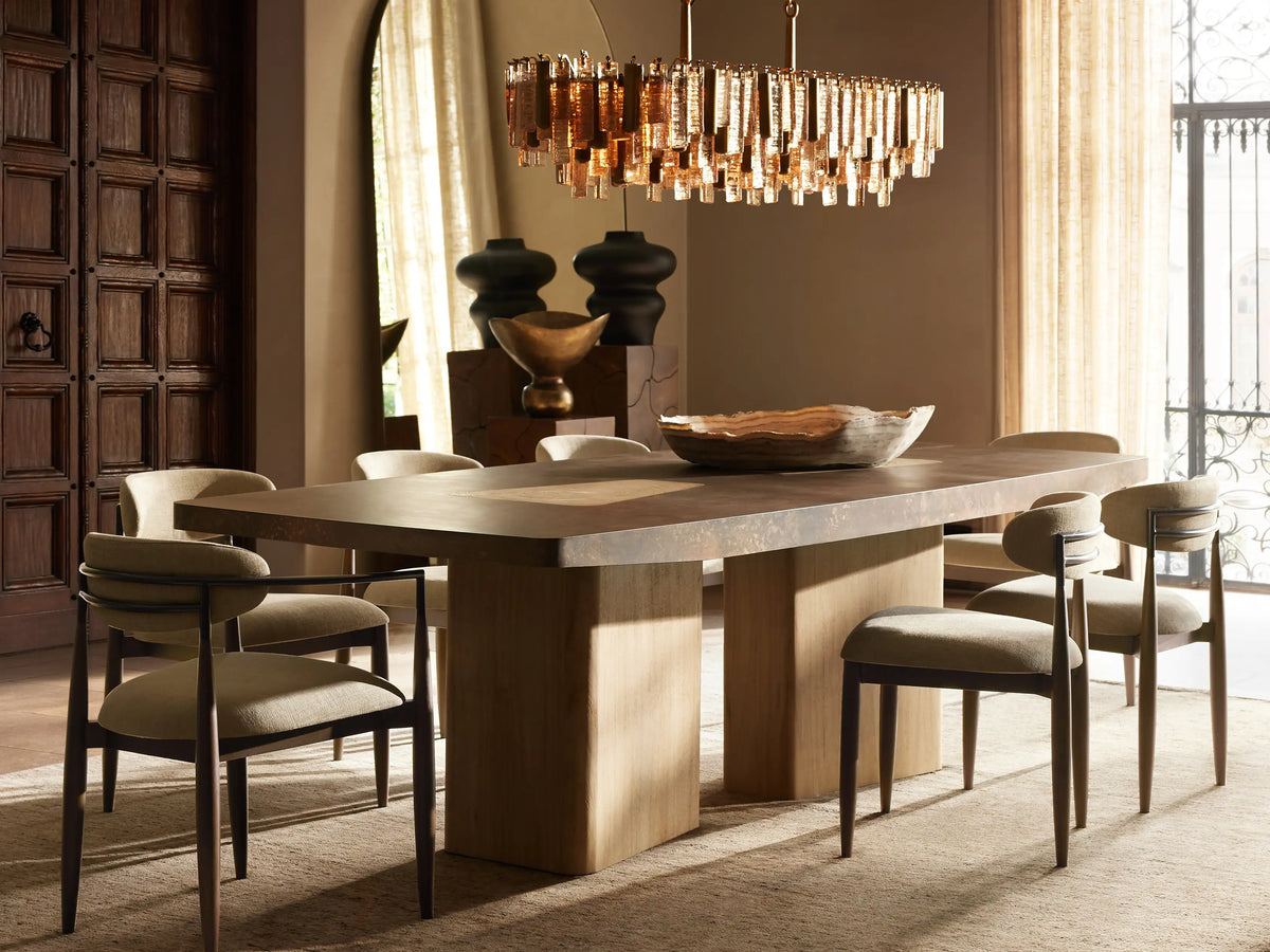 Jagger Dining Arm Chair with white cushioned seat and backrest, black slender legs, and wooden armrests on a wooden floor.