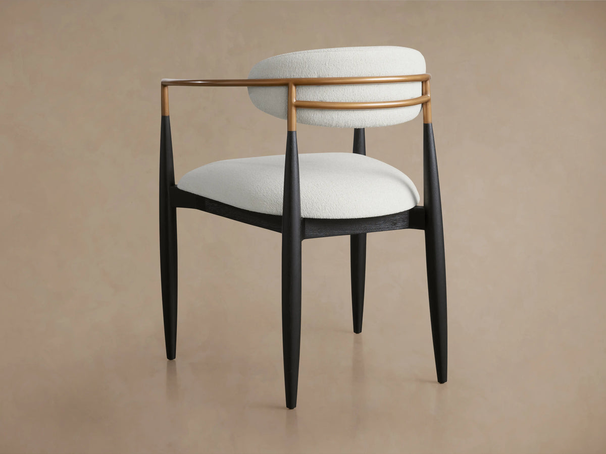 Front view of Jagger Dining Arm Chair featuring white upholstered seat and backrest, with a light brown frame and black legs.
