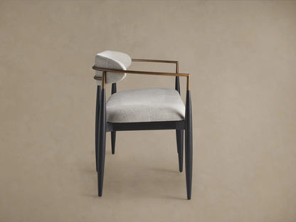 Jagger Dining Bench with a sleek design features light grey cushioned seating and backrest, black legs and arm supports, on wooden floor.