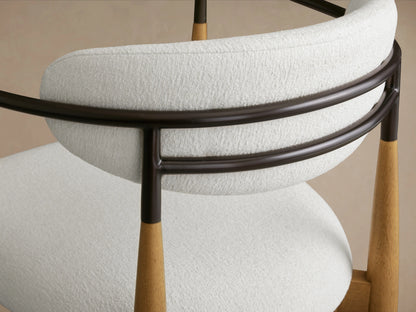Jagger Stool in white Crypton® fabric with a rounded backrest. Features dark brown metal frame and wooden legs with a clear lacquer finish.