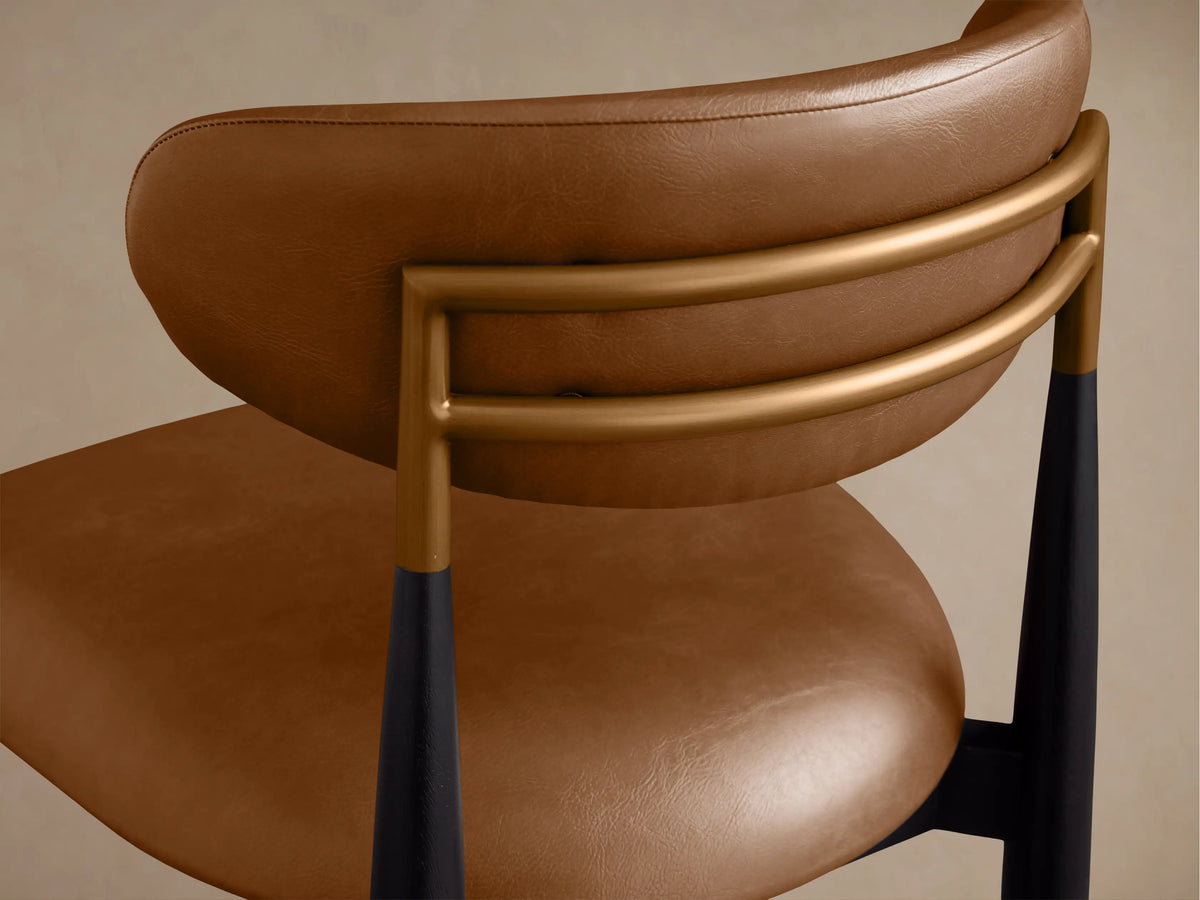 Jagger Faux Leather Dining Side Chair, front view, with brown faux leather seat/backrest, black frame & legs.