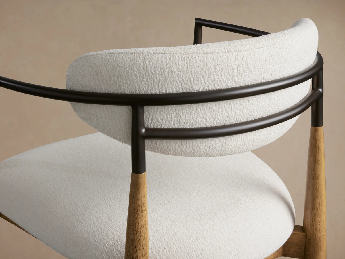 Jagger Barstool in Natural with a white cushioned seat and backrest, wooden legs, and black metal frame on smooth wooden floor.