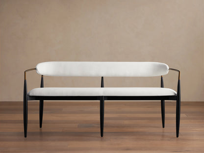Jagger Dining Bench with a sleek black frame and white cushioned seat and backrest. It has a modern design with slender legs and gentle curves.