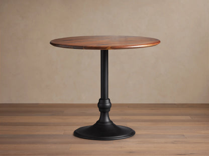 Jacob Counter Table with Wade Base showing a round solid walnut top and a black iron base on wooden floor.