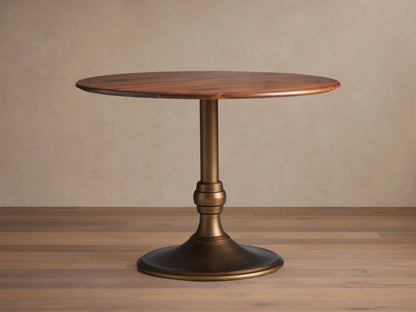 Jacob Bistro Table with a warm walnut round tabletop, supported by an elegant brass-finished Wade Base on a wooden floor.