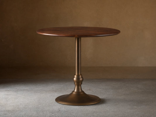 Round Jacob Counter Table with a solid walnut top and a Wade Base in brass finish, set against a light neutral background.
