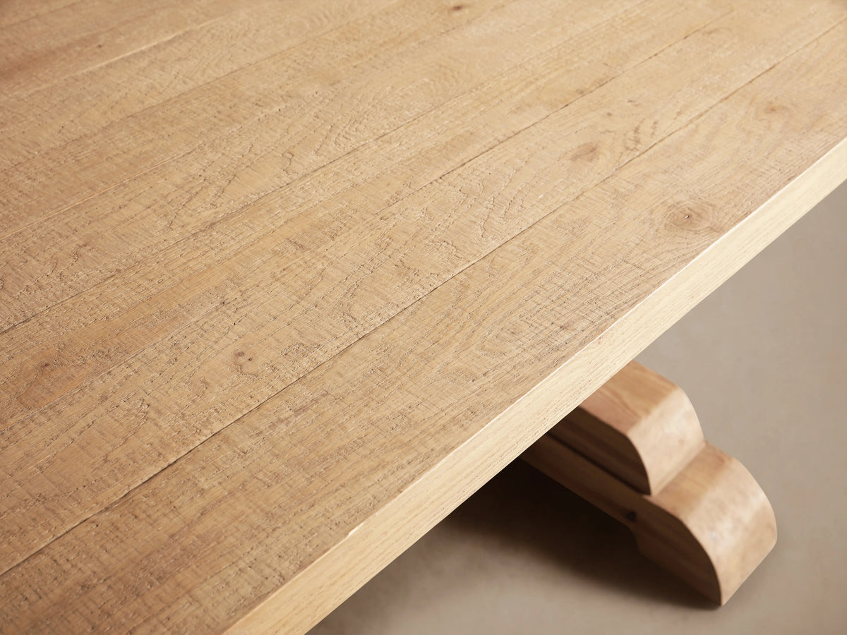 Light oak Kensington Dining Table with rectangular top and two ornate sculpted pedestal bases connected by a stretcher bar.