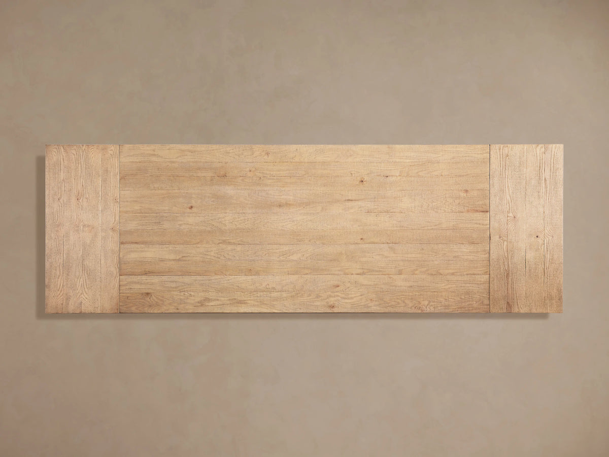 Rectangular Kensington Dining Table top, light oak wood with distinct grain and plank pattern, against a plain brown background.