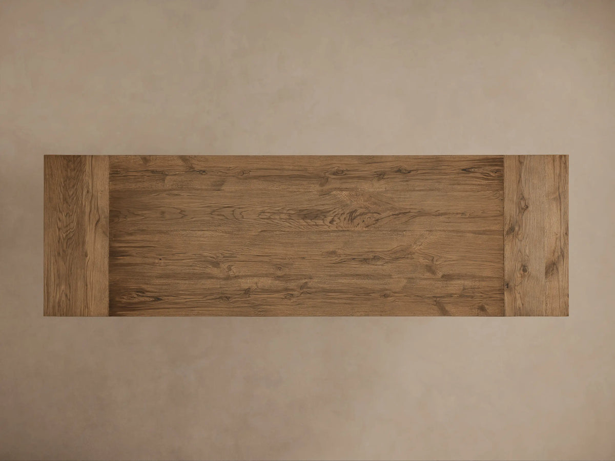 Kensington Reclaimed Dining Table with a thick, textured wooden top and sturdy pedestal base in a natural wood finish.