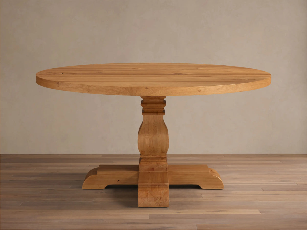 Front view of the natural wood Kensington Round Reclaimed Dining Table, showcasing its round top and sculptural pedestal base.