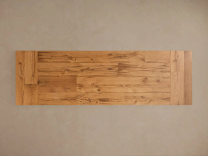 Close-up of Kensington Reclaimed Dining Table showing natural wood grain on light brown oak top & ornate pine pedestal base.