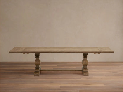 Kensington Reclaimed Dining Table with a natural wood finish, featuring a rectangular top and ornate, chunky pedestal legs.