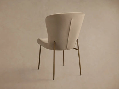 Close-up of Kirsten High Back Dining Chair. Light beige, textured fabric seat and curved back with dark powder-coated iron frame.