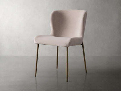 Kirsten Dining Chair in Vanni Linen featuring a soft pink upholstered seat and curved backrest, with slender powder-coated iron legs.