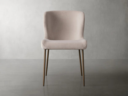 Kirsten Dining Chair in Vanni Linen featuring a soft pink upholstered seat and curved backrest, with slender powder-coated iron legs.