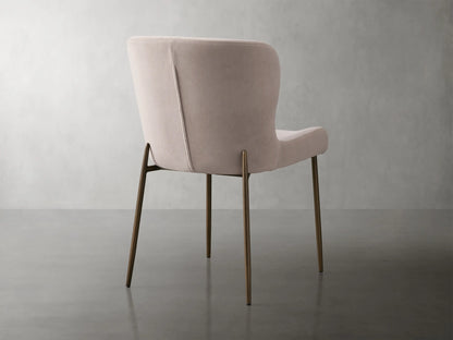 Kirsten Dining Chair in Vanni Linen, featuring a soft beige fabric with curved backrest and iron legs with a textured finish.