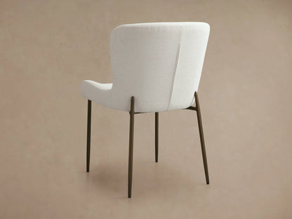 Kirsten Dining Chair with a white upholstered curved backrest, iron legs in a powder-coated finish, shown from the back.