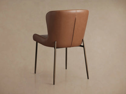 Kirsten Faux Leather Dining Chair in brown faux leather shown from the back, featuring powder-coated iron legs.