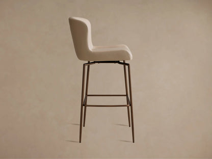 Kirsten Faux Leather Swivel Stool in beige, close-up view showing smooth curved backrest and stitched detailing on faux leather.