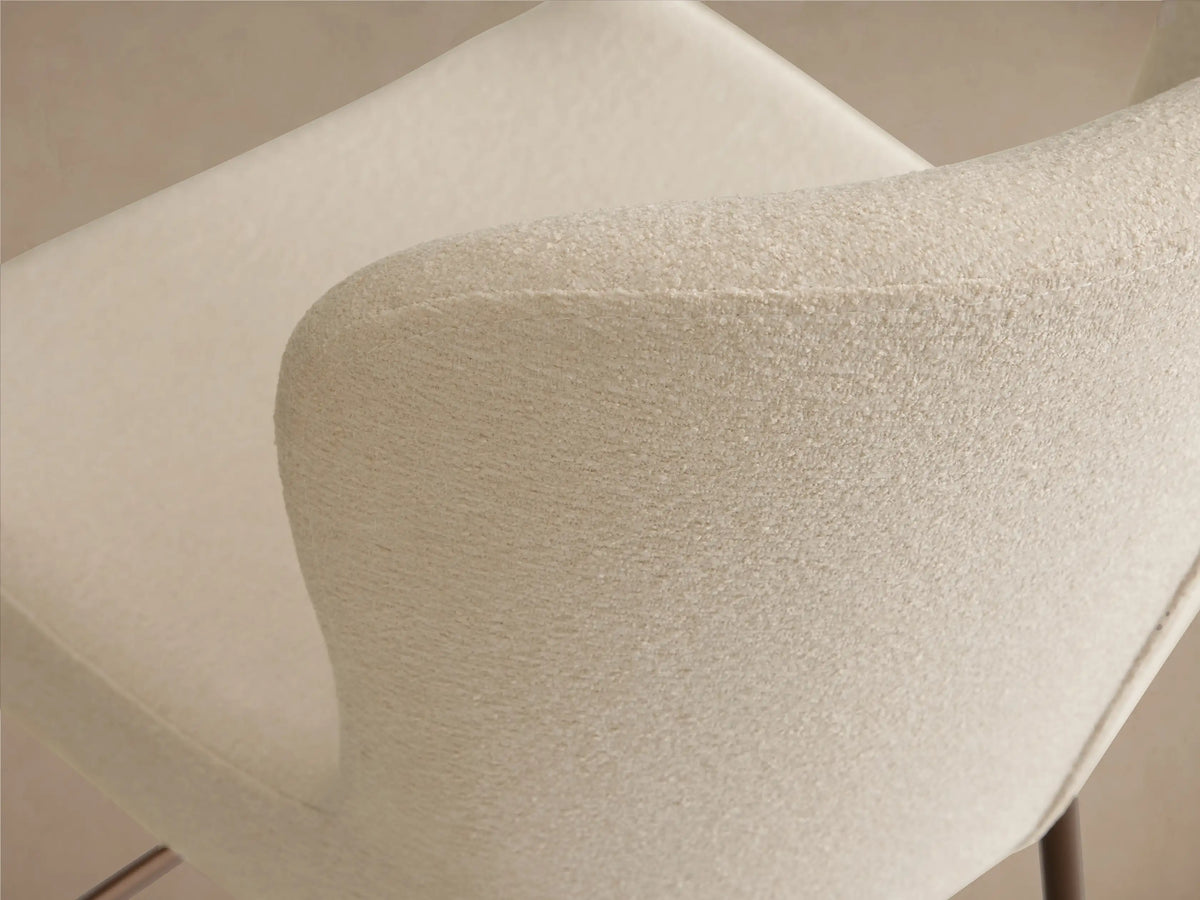 Kirsten Swivel Stool in side view, features a white cushioned seat with a curved backrest, iron frame, and powder-coated legs.
