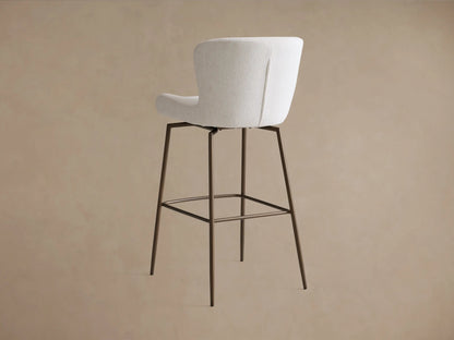 Kirsten Swivel Stool with curved, cushioned backrest and seat in light gray fabric, on dark powder-coated iron legs.
